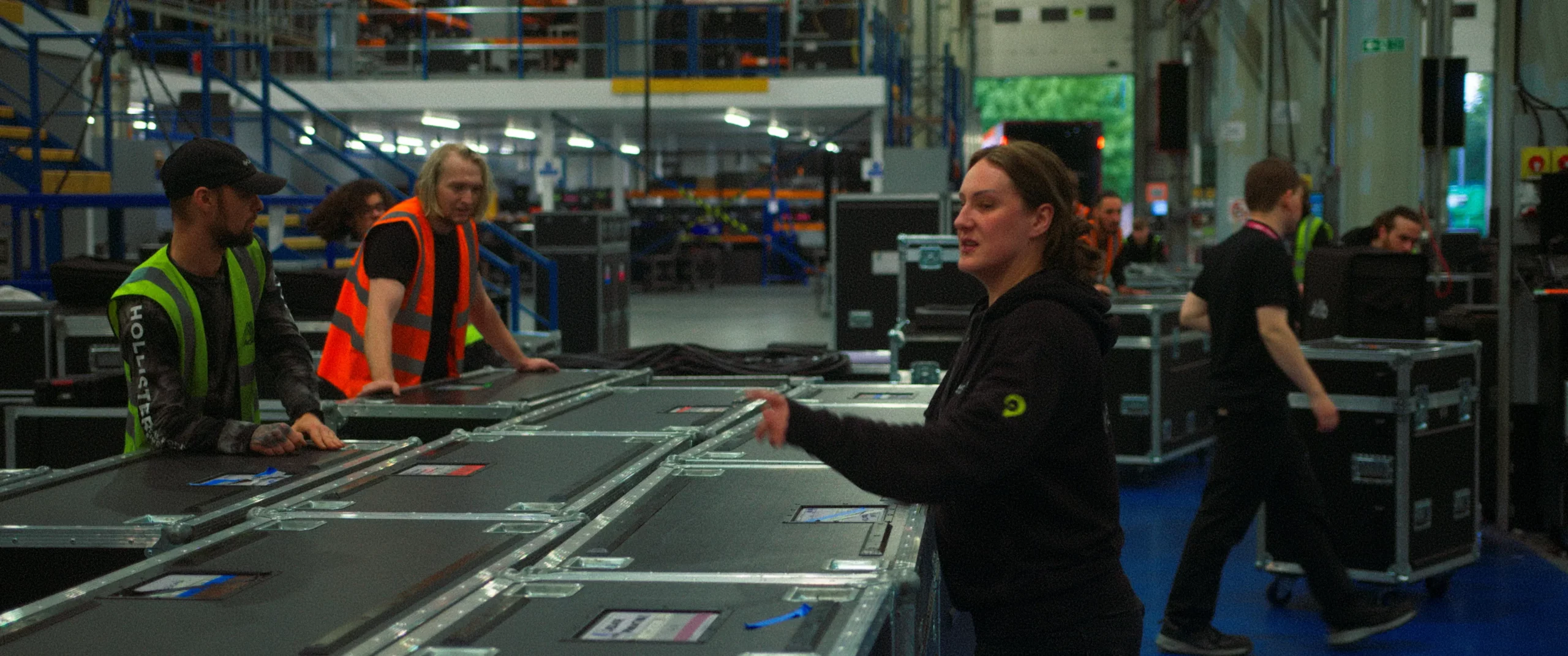 Natalie Gebbie directs warehouse workers during the filming of the short film For You filmed by KINØ